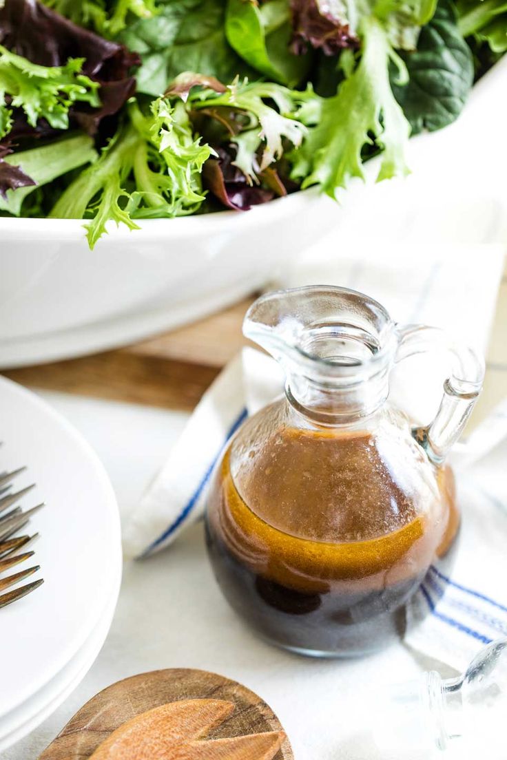 a salad in a bowl with dressing on the side