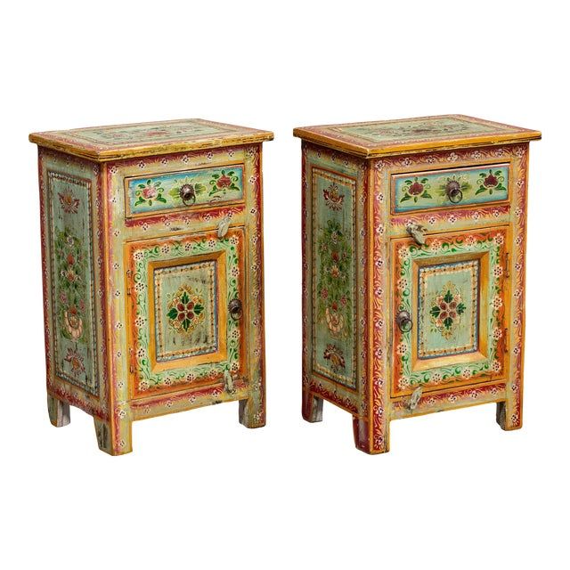 a pair of colorfully painted nightstands sitting next to each other