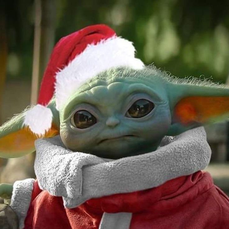 the baby yoda is wearing a santa hat