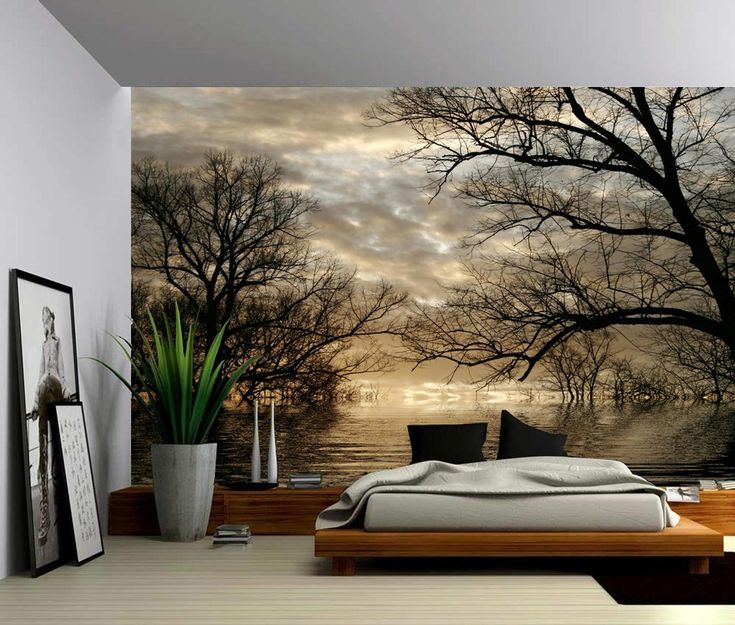 a bedroom with a large mural on the wall and a bed in front of it