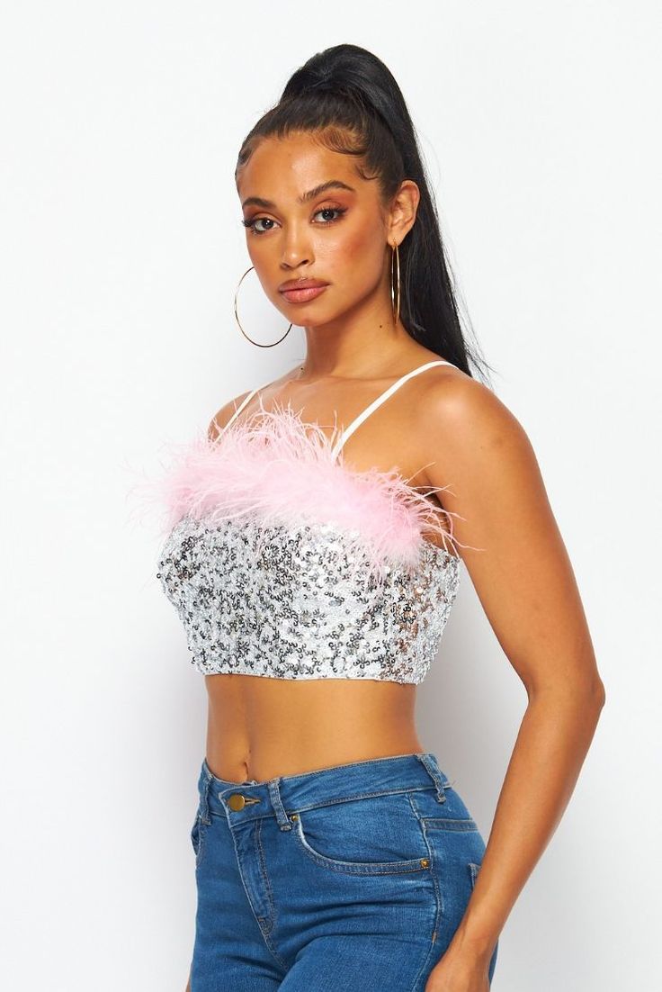 Dazzling sequins and pink feathers pave the way on this spectacular crop that's sure to be a hit from celebrations to nights on the town. • Pink Feather Trim• Adj. Straps• Pull On• Crop• Silver Sequins