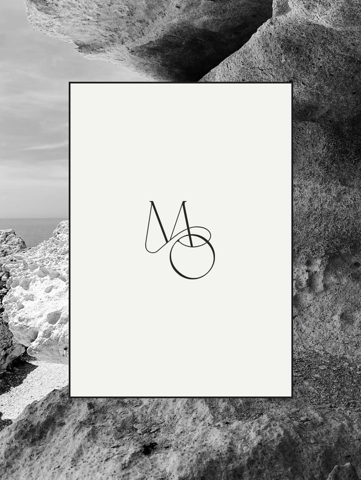 a black and white photo with the letter m in it's center surrounded by rocks