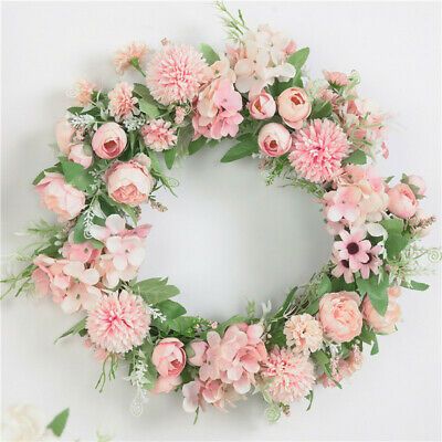 a floral wreath with pink flowers and greenery