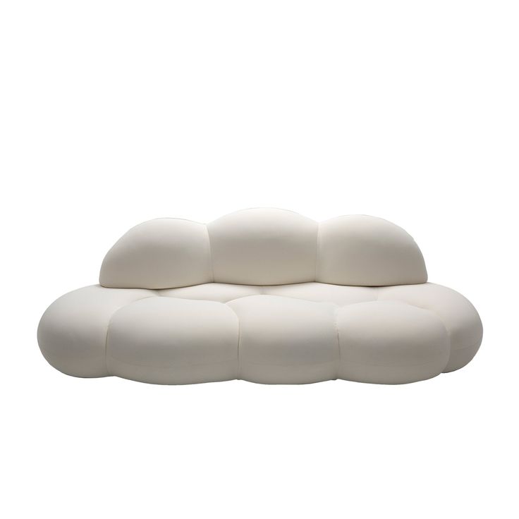 a white couch sitting on top of a white floor