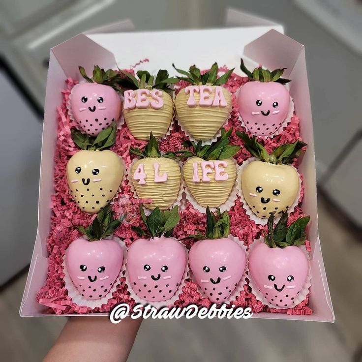 a box filled with chocolate covered strawberries and smiling faces