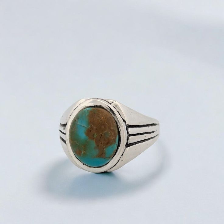 Introducing the Weeping Mary ring, a vintage-inspired piece crafted from sterling silver. This artisan ring boasts an intricate, vintage-style cast design, giving it a touch of timeless elegance. At its heart lies a mesmerizing green-toned Kingman turquoise cabochon, known for its unique and captivating beauty. Sized at 11, this ring ensures a comfortable fit while making a bold and stylish statement. Features Handcrafted sterling silver: Beautifully designed with a vintage touch. Green Kingman Antique Turquoise Sterling Silver Ring, Handmade Classic Turquoise Sterling Silver Ring, Handmade Classic Sterling Silver Turquoise Ring, Heirloom Style Turquoise Sterling Silver Ring, Antique Silver Turquoise Ring With Patina, Classic Adjustable Turquoise Ring In Sterling Silver, Vintage Handmade Oval Turquoise Ring, Vintage Sterling Silver Open Ring, Vintage Blue Turquoise Ring Engraved