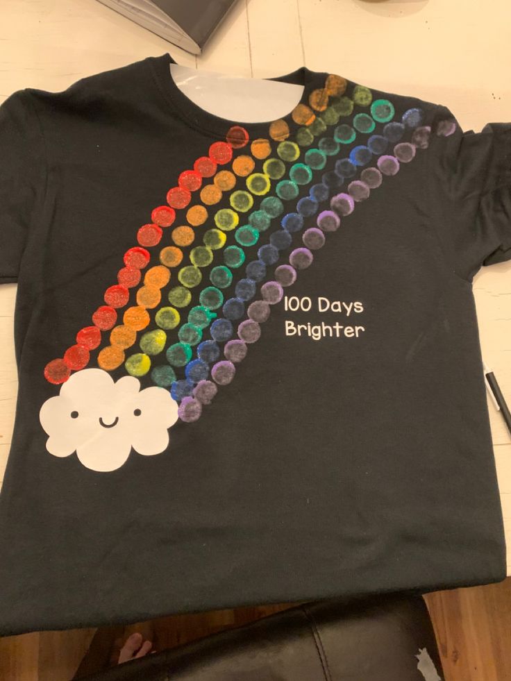 a t - shirt that says 100 days brighter with a rainbow and clouds on it