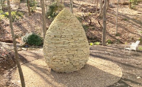 a stone structure in the middle of a forest