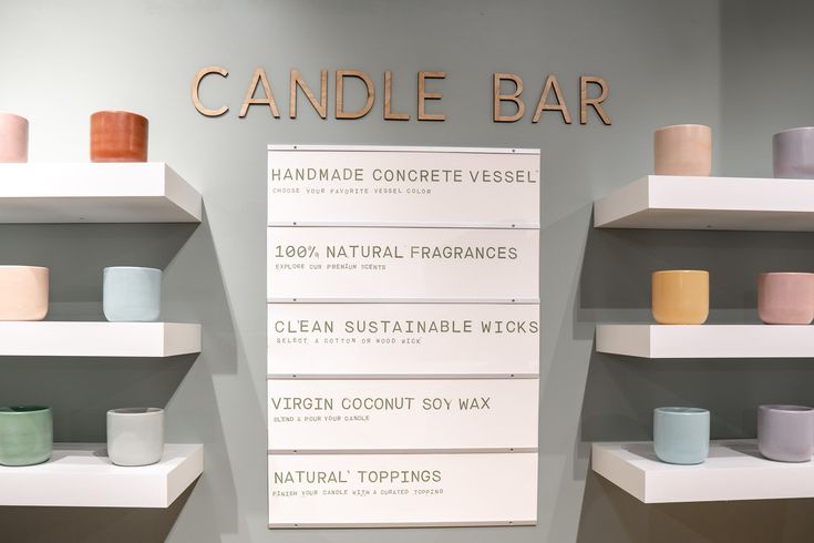 there are many candles on the shelves in this display case that is labeled candle bar