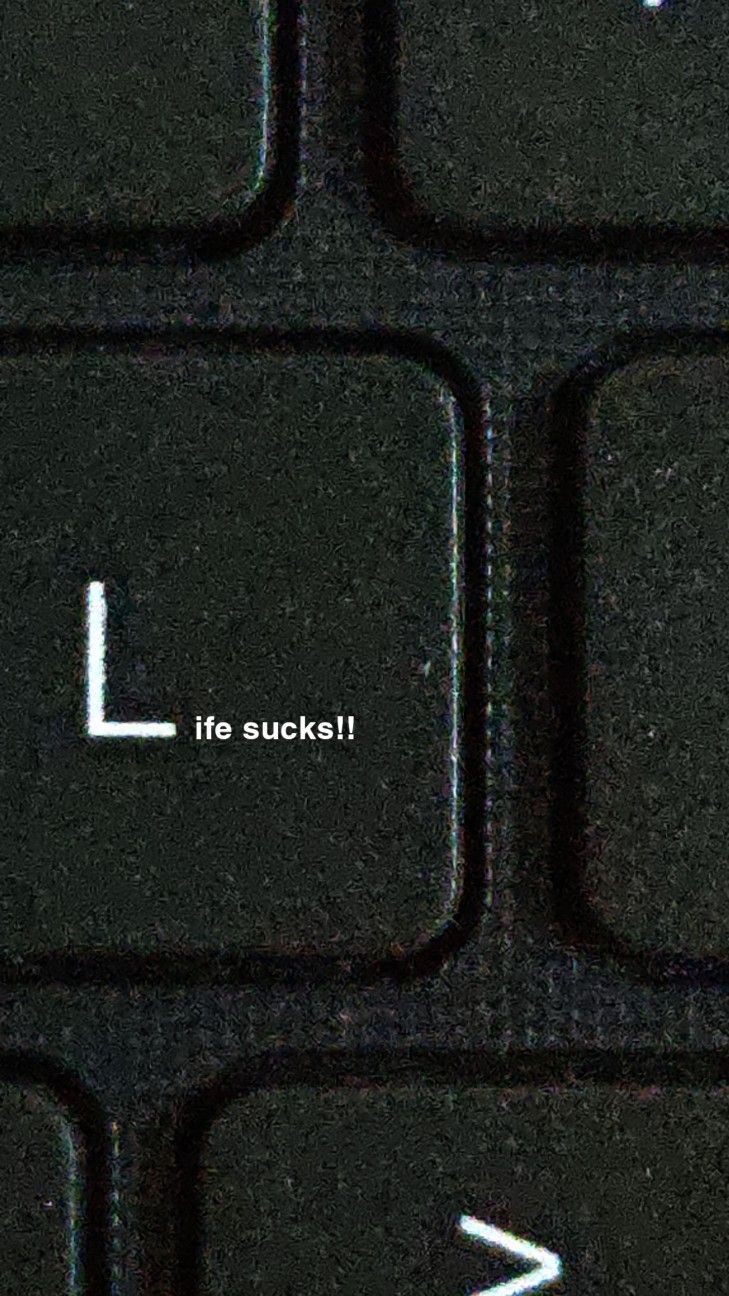 a close up of a keyboard with the word life suckle on it's left side