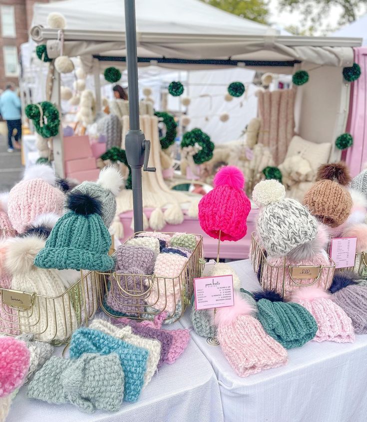 knitted hats and mittens on display at an outdoor market