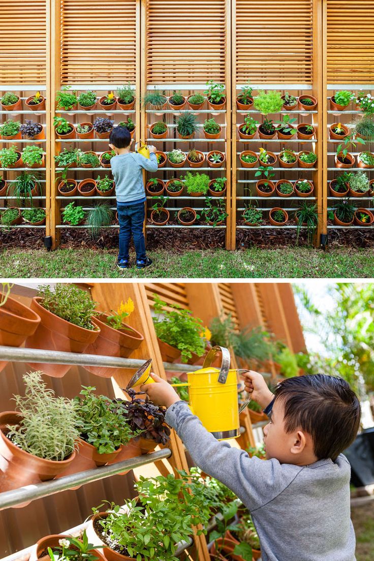 a boy is watering plants in the garden and another kid is holding a yellow cup