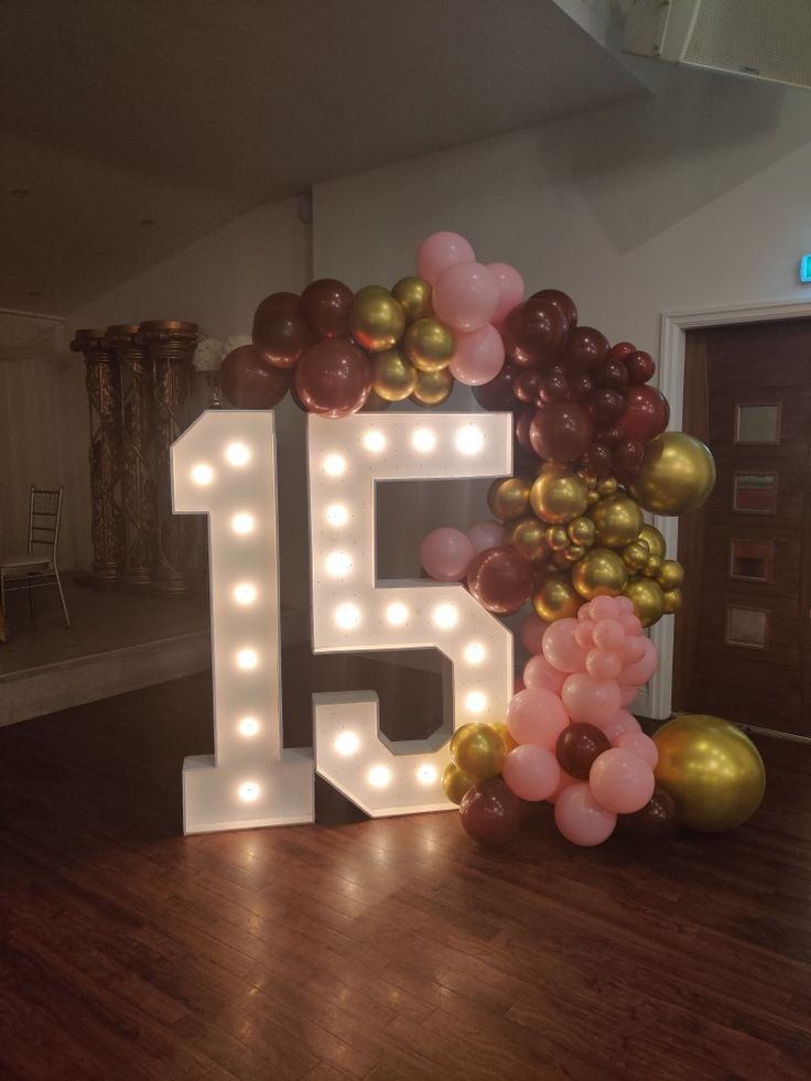 the number fifteen is surrounded by balloons and streamers