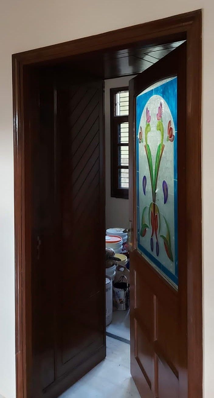 an open door leading to a room with a painting on the wall and flooring