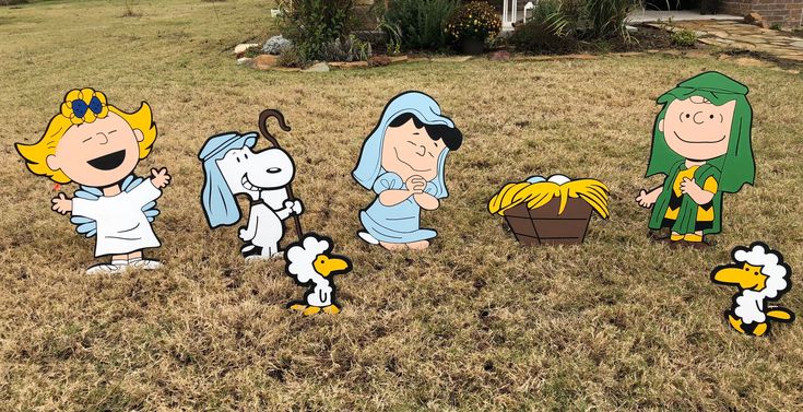 cartoon characters are standing in the grass