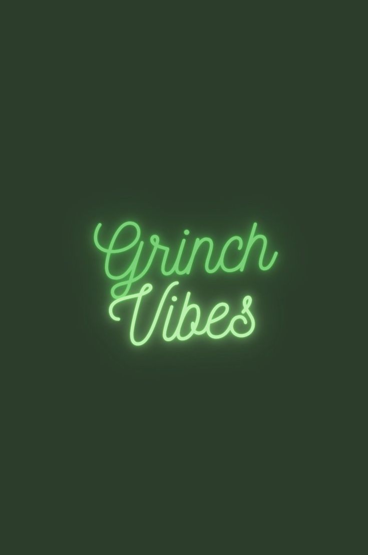 the words grin vibes are lit up in green neon lights on a dark background