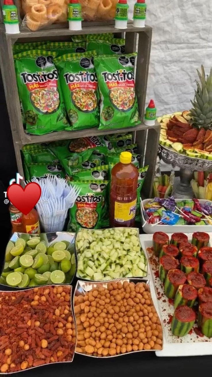 a table filled with lots of different types of food and snacks on it's sides