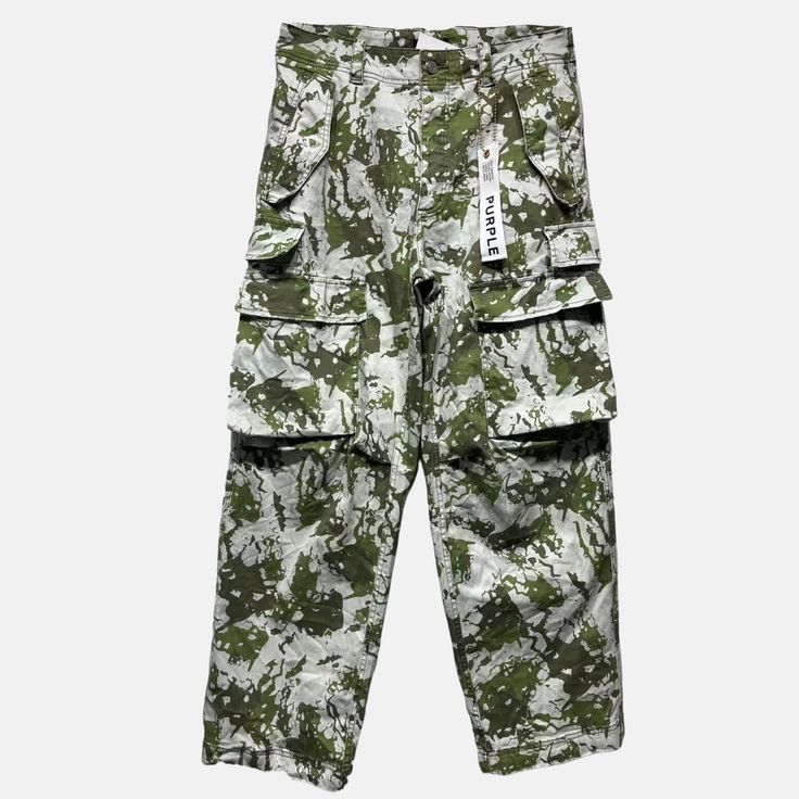 Style No. P527-DPMG124 Color: Green/Multicolor Cut from sturdy camo-print fabric, this cargo pant is a utilitarian classic. It has multiple pockets, including four at the sides and two at the legs, finished with an inner lining, and signature hang tag branding. Baggy. Mid Rise. Brushed Twill. Allover Digit Print. Double Cargo Pockets. Drawcords at Waistbands and Hem. Purple Brand P527 Double Pocket Cargo. Military Style Cargo Jeans With Multiple Pockets For Streetwear, Military Style Cargo Pants With Multiple Pockets For Streetwear, Utility Camouflage Bottoms With Multiple Pockets, Camouflage Bottoms With Multiple Pockets For Outdoor, Utility Style Camouflage Bottoms With Multiple Pockets, Camouflage Outdoor Bottoms With Multiple Pockets, Camouflage Utility Parachute Pants With Cargo Style, Outdoor Camouflage Cargo Pants With Side Pockets, Camouflage Cargo Style Parachute Pants