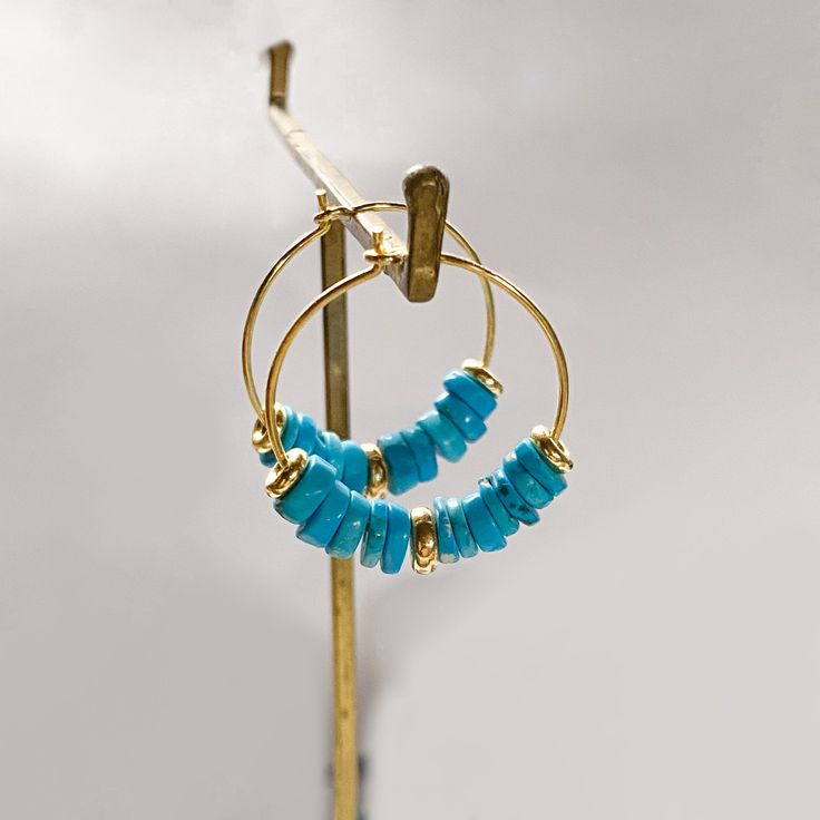 These turquoise gold hoop earrings in 925 sterling silver with a boho desing, is the perfect gemstone earrings for women for a summer season. Turquoise is the December birthstone also perfect for a Gift. DETAILS *Material: High Quality solid 925 sterling silver or silver plated in 18k gold. Turquoise heishi beads. *Dimensions: *Diameter of the hoops is 23mm. *The diameter of the turquoise beads is 6 mm. *Sold in pairs. * Also avalaible in white shell here : https://www.etsy.com/listing/118545906 14k Gold Filled Gemstone Hoop Earrings, Adjustable Tarnish Resistant Hoop Jewelry, Adjustable Gold Plated Hoop Jewelry, Adjustable Gold-plated Hoop Jewelry, Adjustable Gemstone Hoop Jewelry, Small Hoop Earrings With Natural Stones, Single Hoop Earring As A Gift, Gold Plated Single Earring As Gift For Her, Nickel-free Hoop Fine Jewelry