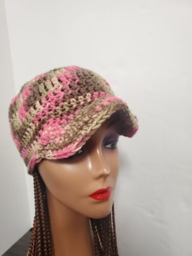 a mannequin head wearing a hat with braids