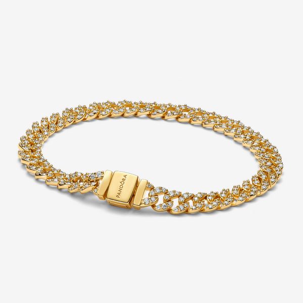 Elevate your look with the Pavé Cuban Chain Bracelet. This 14k gold-plated bracelet features sparkling links in a chain. The top of each half circle is set with three round stones, while the back of the chain is polished for shine and comfort. The bracelet closes with a flat, square-shaped clasp featuring an engraved Pandora logo. - Pandora Pavé Cuban Chain Bracelet - 14k Gold-plated unique metal blend / Cubic Zirconia / Clear - Sz. 7.9 in Gold Diamond Chain Link Bracelet, Formal Cubic Zirconia Chain Bracelet, Tarnish Resistant, Formal Cuban Link Chain Bracelet With Cubic Zirconia, Diamond Cuban Link Bracelet In Yellow Gold, Formal Chain Link Jewelry With Cubic Zirconia, Luxury Cubic Zirconia Chain Link Jewelry, Yellow Gold Diamond Cuban Link Bracelets, Gold Cuban Link Diamond Jewelry, Classic Gold Chain Bracelet With Diamond Accents