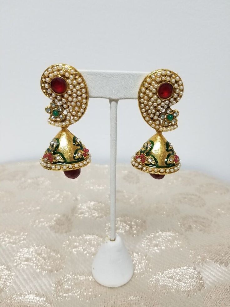 Stunning traditional indian earring will wow at your next festive occasion 22k yellow gold plated, hypoallergenic nickle and lead free Cubic zirconia, Pearl  Red Onyx, and Green Onyx Gemstone Pushback closure Jhumka Style earring Elegant Jeweled Earrings For Diwali, 22k Gold Bollywood Meenakari Jhumkas, Festive Jeweled Bollywood Chandbalis, Jeweled Drop Earrings For Festivals, Traditional Jeweled Dangle Danglers, Jeweled Drop Danglers For Festivals, Festive Jeweled Bridal Earrings For Formal Occasions, 22k Gold Meenakari Earrings For Navratri, Festival Chandbali Earrings In Cubic Zirconia