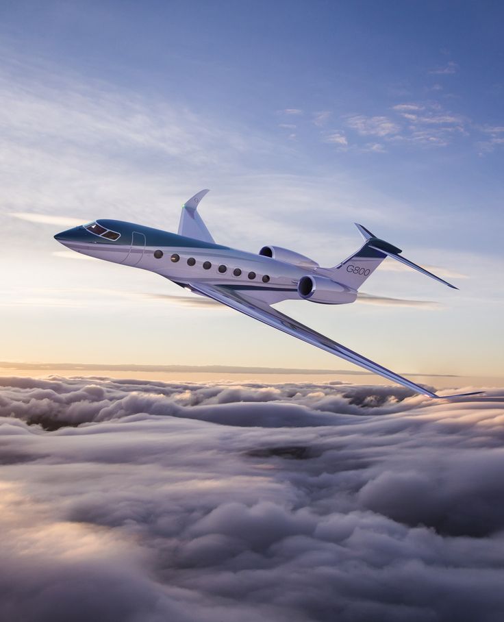 an airplane flying above the clouds at sunset