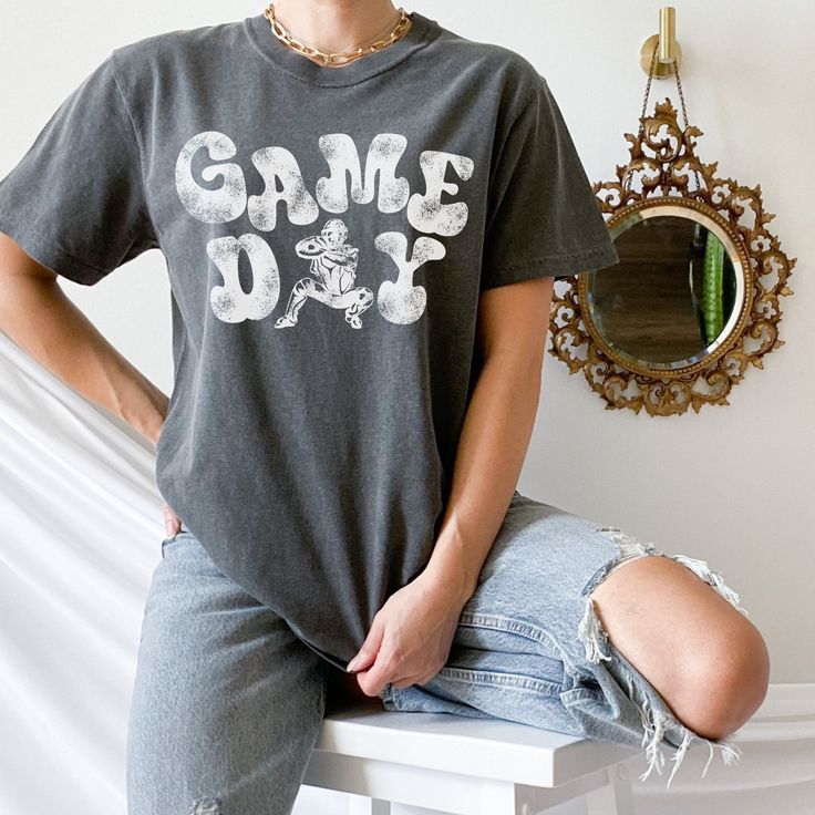 Show your love of the game with this vintage style catchers design on the popular comfort colors tee. This is a great baseball shirt for the game and everyday wear! It Makes the perfect catcher's mom gift! This garment-dyed t-shirt is made with 100% ring-spun cotton. The soft-washed, garment-dyed fabric brings extra coziness to your wardrobe while the relaxed fit makes it an excellent daily choice. The double-needle stitching throughout the tee makes it highly durable while the lack of side-seams helps the shirt retain its tubular shape. **If for some reason your particular brand and color shirt is out of stock, another high quality shirt of similar color will be substituted. If an alternative isn't available I will message you. If you prefer not to have a substitution please message me be Vintage Letter Print Tops For Game Day, Vintage Game Day Tops With Team Name, Soft-washed Tops For Game Day Fan Apparel, Vintage Game Day Top With Team Name, Game Day Letter Print T-shirt For Baseball Season, Retro Letter Print T-shirt For Game Day, Baseball Season Sports T-shirt, Soft-washed Fan Apparel T-shirt For Game Day, Baseball Season Sports Fan T-shirt