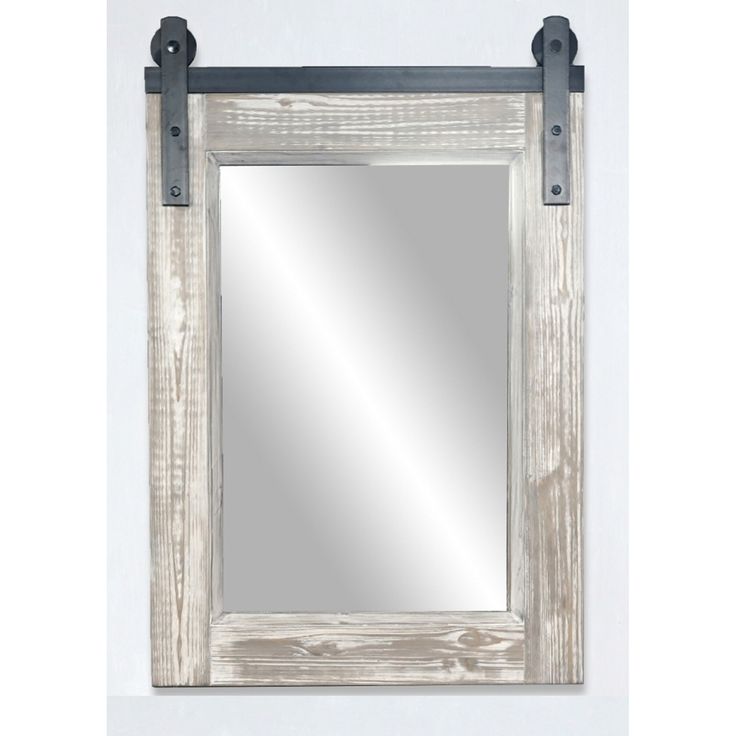 a mirror hanging on the side of a white wall with black metal straps around it