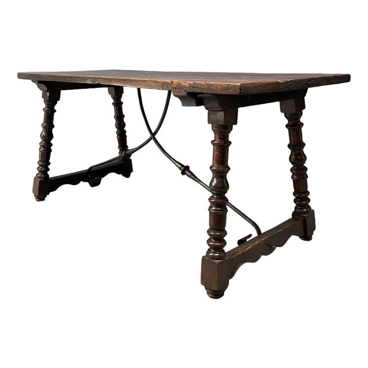 an old wooden table with two legs and one leg bent down to the side, on a white background