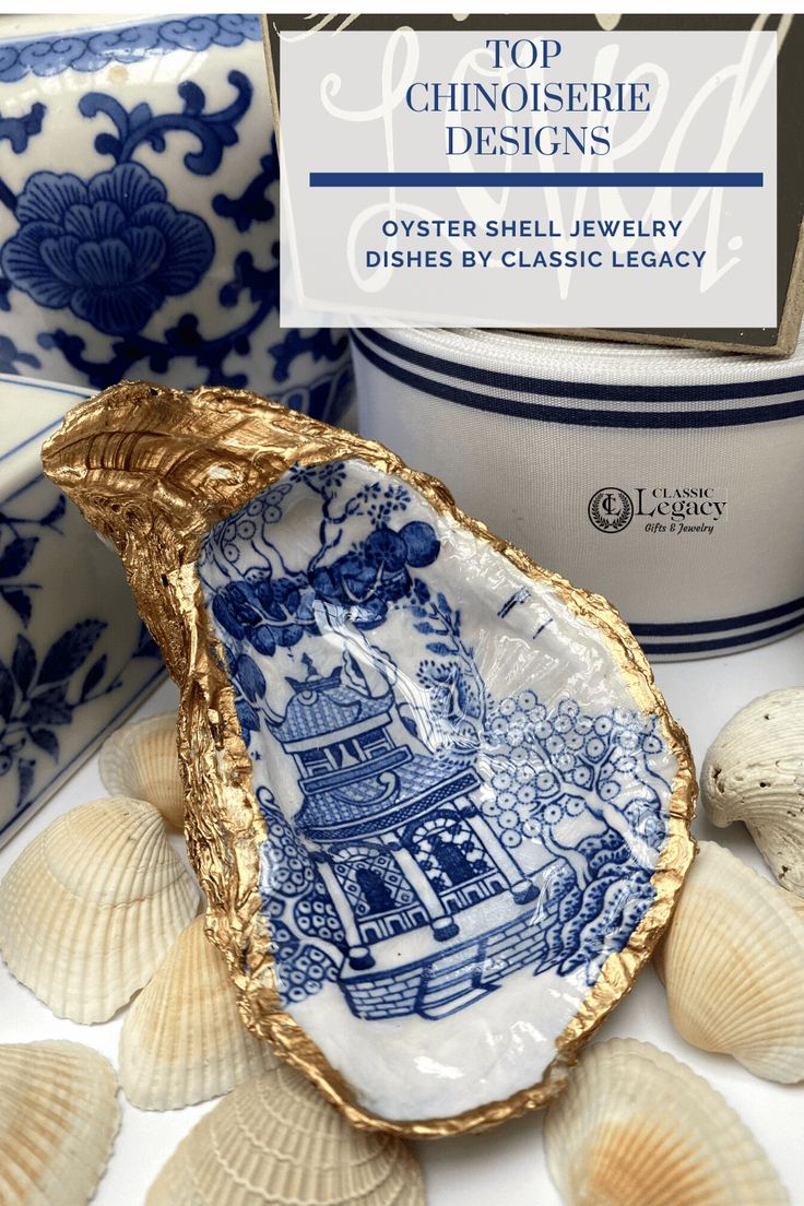 an oyster shell with blue and white designs on it, surrounded by seashells