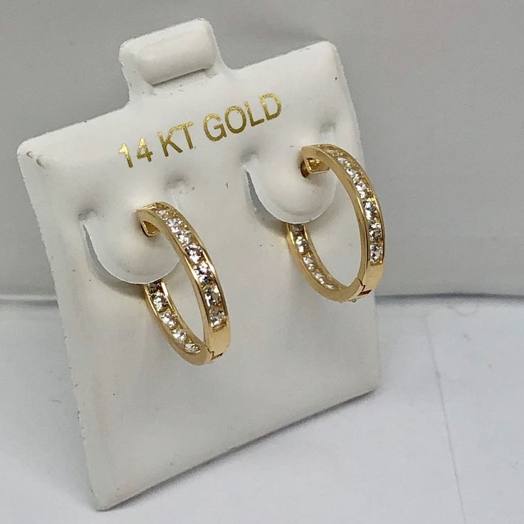 14k Pure Solid Yellow/White Gold Huggie Earrings With A Hinge/Notched Post Fastening And Dazzling Cubic Zirconia Stones (Not Gold Filled). -Number Of Stones-30 (15 Each) -Length: 16mm -Width: 3mm Luxury Gold Huggie Earrings Channel Set, Gold Diamond Earrings Channel Set, Yellow Gold Diamond Earrings With Channel Set, Yellow Gold Diamond Channel Set Earrings, 14k Stamped Huggie Earrings For Anniversary, 14k Huggie Earrings For Anniversary, Yellow Gold Channel Set Earrings For Anniversary, 14k Stamped Yellow Gold Huggie Earrings, Fine Jewelry Yellow Gold Hoop Earrings Channel Set