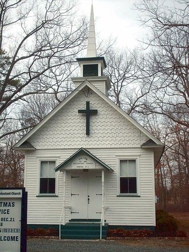 a white church with a cross on the front