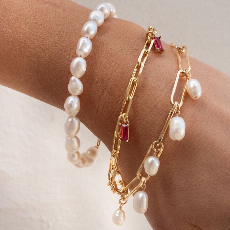 Our Cora Pearl Bracelet is so simple yet absolutely eye-catching. What do we love about it? This bracelet is timeless and modern - perfect as a gift or gifted to yourself! BRACELET FEATURES Small Genuine Freshwater Baroque Pearls Choice of Yellow Gold, Rose Gold or Sterling Silver Finish Bracelet includes a 1" extender All bracelet findings (clasp, end tags, jump rings) and extender chain are 100% gold filled or sterling silver to ensure the highest quality piece Bracelet available in 2 sizes: S Modern Charm Bracelet, Pearl Bracelet Making, Gold Bracelet With Charms, Charms Bracelet, Pearl Bracelet Stack, Bridesmaid Pearl Bracelet, Pearl Charm Bracelet, Gold Pearl Bracelet, Chunky Pearls