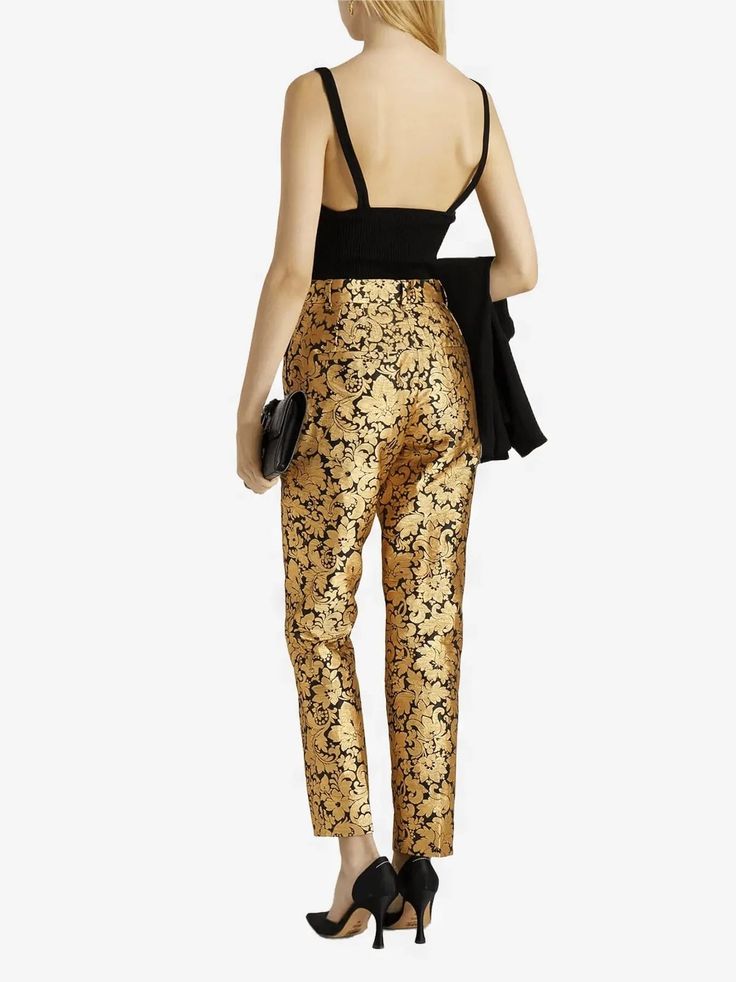 Cut for a tailored silhouette with pressed creases, these Dolce & Gabbana Metallic Jacquard Pants are designed to create bold, timeless look. The soft fabric is accented shimmering gold that adds an elegant finish. Zipper and button-closure pockets lend contemporary edge this chic design.Material: 83% Polyester 17% FiberZipper button closureLogo detailsMade in Italy Model 175cm/ 5'9" wearing IT 40Designed slim fit, tapered at hemFits true size, take your normal size IT42 Measurements:Waist: 74 c Elegant Festive Pants, Elegant Sequined Bottoms For Evening, Silk Tapered Leg Bottoms For Evening, Luxury Sequined Bottoms For Formal Occasions, Luxury Fitted Sequin Bottoms, Elegant Sequined Bottoms For Gala, Gold Silk Bottoms For Party, Elegant Gold Silk Bottoms, Luxury Sequined Bottoms