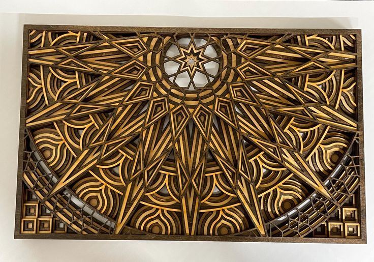 an intricately designed wooden box with a circular window in the center, on a white background