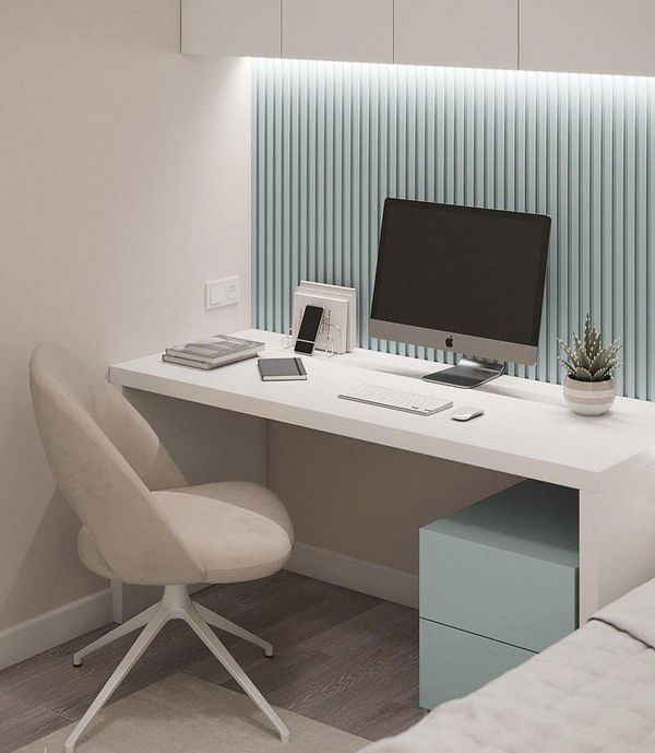 a white desk with a computer monitor and keyboard