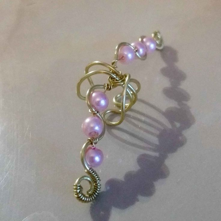 Beautiful handmade adjustable brass ear cuff. The ear cuff covers a large portion of the ear and can be adjusted to the shape of your ear. Very elegant and stunning on the ear with its lovely pink glass pearls. The ear cuff is a light gold colour. The ear cuff adjusts perfectly to any size ear. No need for piercing as they just slip on to any ear. This listing is for one ear cuff. The same one can be worn on either ear. Please contact me for other coloured pearls. *New* Your ear cuff will arrive Bohemian Adjustable Single Ear Cuff, Adjustable Gold Clip-on Ear Cuff, Adjustable Rose Gold Ear Cuff, Adjustable Gold Cartilage Earrings For Party, Adjustable Unique Ear Cuff, Adjustable Bohemian Single Ear Cuff, Handmade Adjustable Cartilage Earrings For Party, Adjustable Bohemian Wrap Earrings For Party, Unique Adjustable Nickel-free Ear Climbers