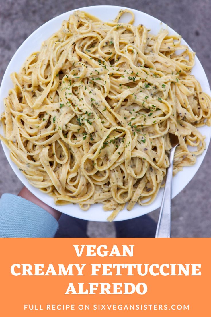 vegan creamy fettuccine alfredo on a white plate with text overlay