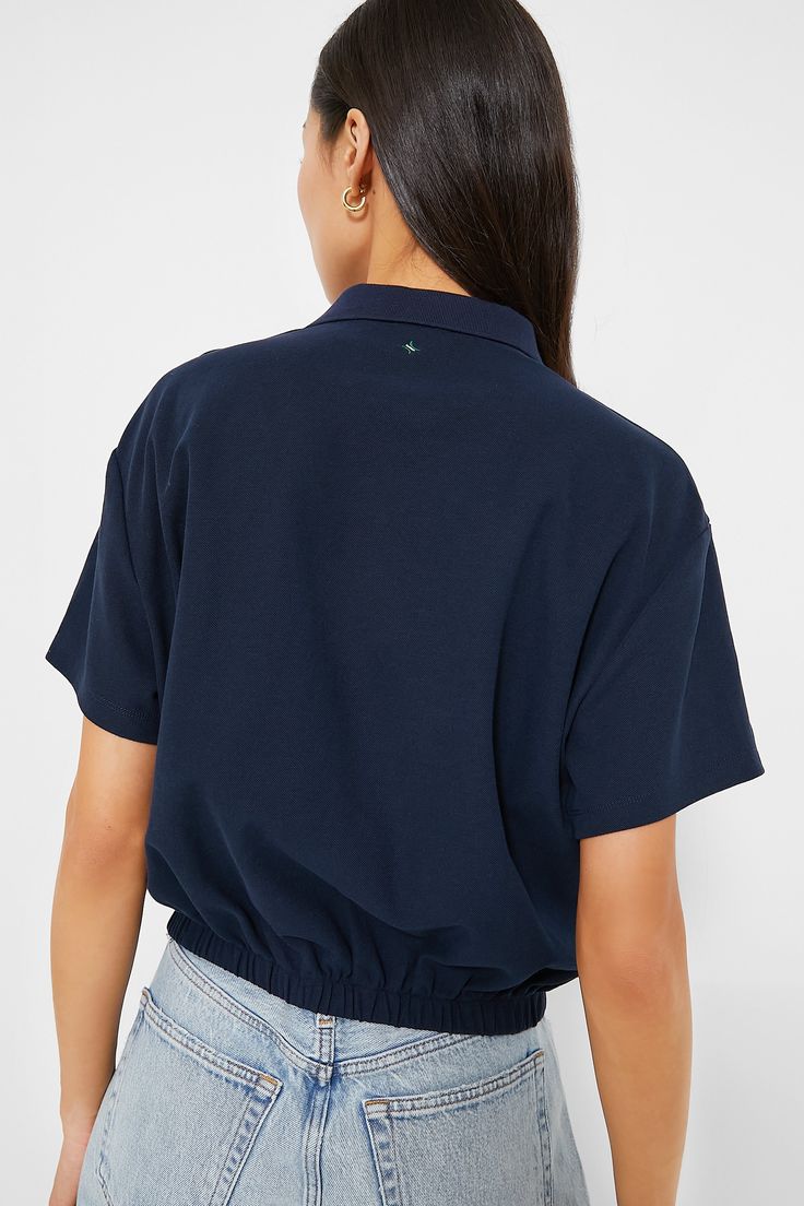 We can't stop talking about the Navy Collins Polo- and for good reason! This classic style staple includes a collar, partial front button placket, and and elastic waistband that gives you a clean, cinched in look without the fuss of tucking in your shirt. Pair with wide leg trousers and loafers for work, or with denim shorts and sneakers for weekend play. Collar Short sleeves Front two button placket Relaxed fit Elastic waistband Material: 65% Cotton, 35% Polyester Care: Hand wash cold, hang to Plus And Minus, Cocktail Attire, The Navy, Stop Talking, Night Looks, Office Fashion, Pullover Sweatshirts, Wide Leg Trousers, Button Placket