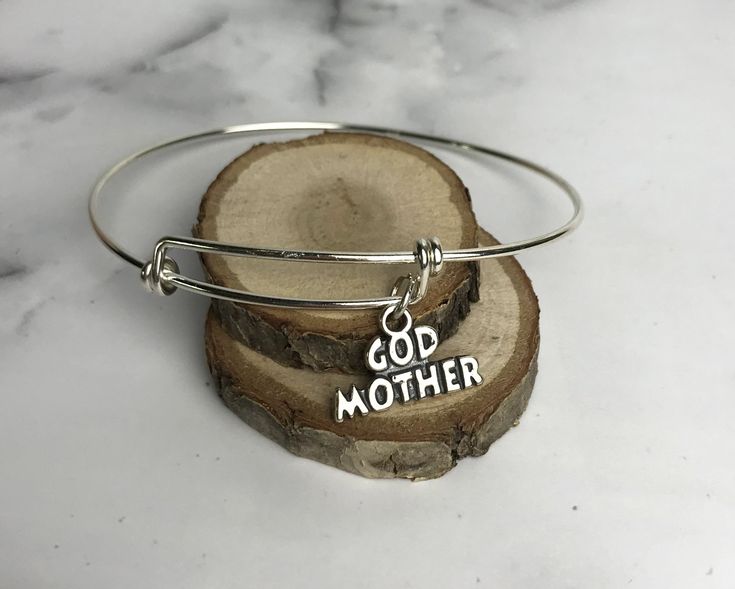 To My Godmother...I am grateful to have such an incredible woman help guide me through life. Happy Birthday! This beautiful sentiment includes a sterling silver adjustable bangle (one size fits most) with a sterling silver godmother charm. Comes in a jewelry box tied with ribbon. Sending this directly to someone? Be sure to include a note during the checkout process. Adjustable Jewelry For Anniversary And Mother's Day, Adjustable Jewelry For Mother's Day Anniversary, Inspirational Silver Jewelry For Birthday, Meaningful Adjustable Jewelry For Mother's Day, Adjustable Meaningful Jewelry For Mother's Day, Adjustable Silver Jewelry Gift For Mom, Adjustable Hallmark Jewelry For Gifts, Inspirational Hypoallergenic Jewelry For Mother's Day, Hypoallergenic Sterling Silver Bracelet For Mother's Day