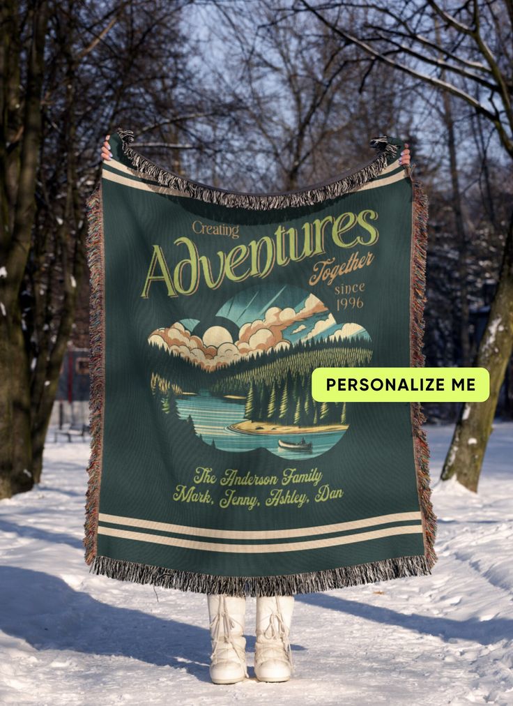 a person standing in the snow with a blanket over their head that says, adventures