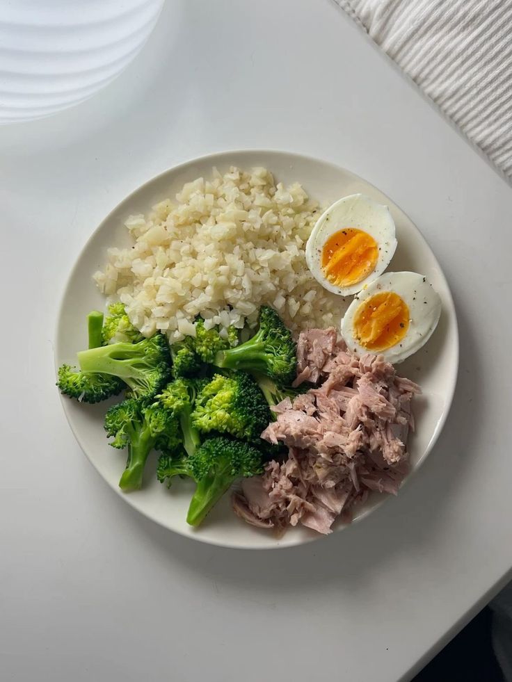 a plate with rice, broccoli and eggs on it