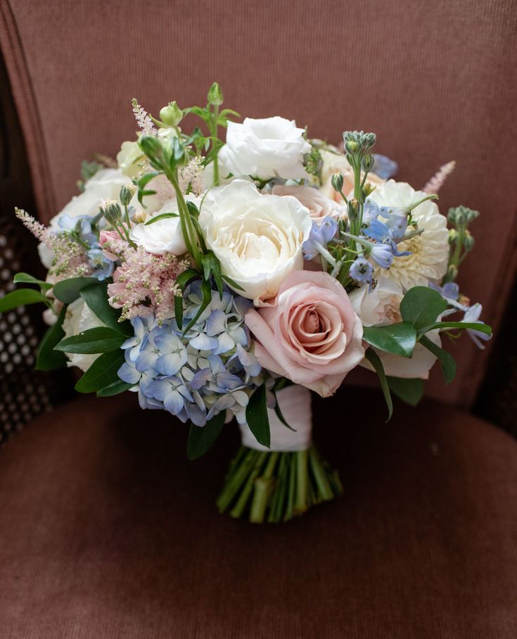 a bouquet of flowers sitting on top of a chair