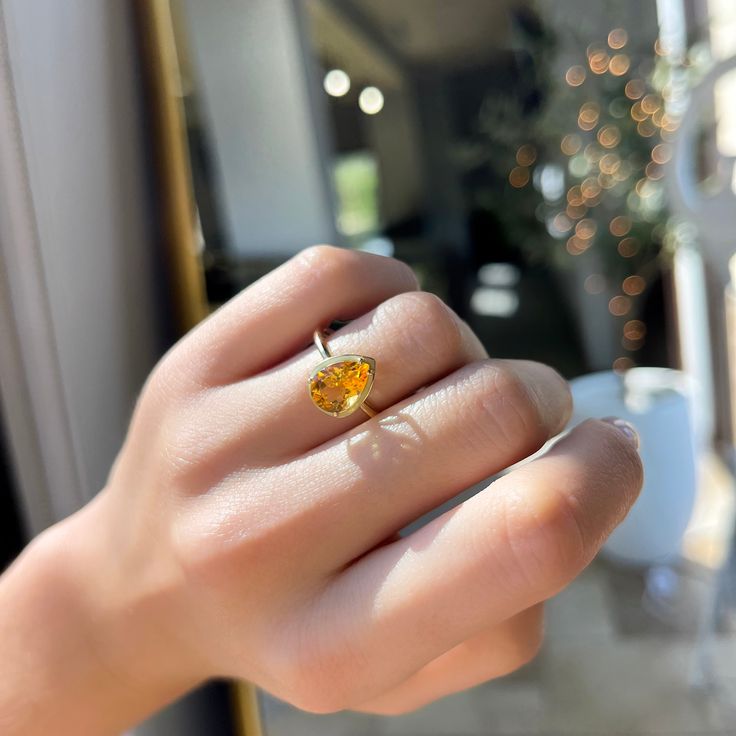 14K Yellow Gold Pear Shape Citrine Light Orange Enamel Halo 1.59 Total Citrine Carat Weight Solitaire Band Stock Size: 7 Fine Jewelry Pear-shaped For Proposal, Luxury Pear-shaped Gemstone Rings, Yellow Gold Teardrop Jewelry For Proposal, Pear-shaped Prong Setting Jewelry For Proposal, Yellow Pear Shaped Fine Jewelry Rings, Pear Shaped Prong Setting Jewelry For Proposal, Gold Pear-shaped Opal Ring Gift, Luxury Pear-shaped Ring As Gift, Luxury Pear-shaped Ring For Gift