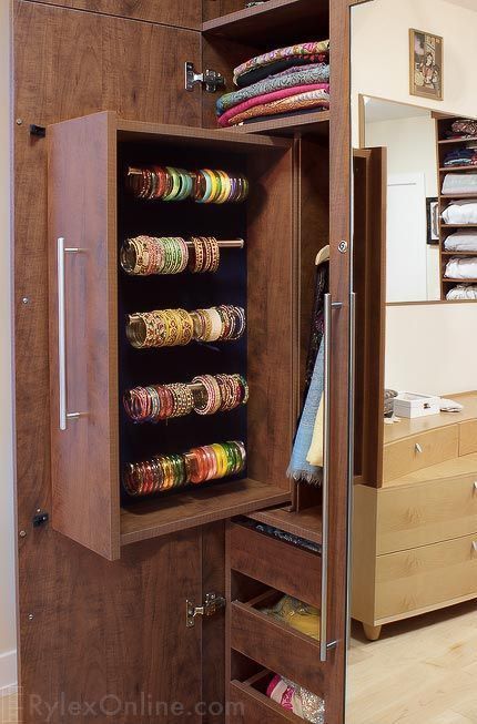 a closet with many different types of bracelets and other jewelry items in it's drawers