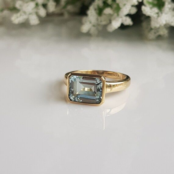 RING DETAILS:✪Design: Gold ring✪Gemstone: Natural aquamarine✪Gemstone color: Blue✪Gemstone size: 8x10 mm✪Gemstone shape: Emerald cut✪Gemstone transparency: Transparent✪Setting type: Bezel setting✪Metal type: 14k solid yellow gold✪Metal finish: Smooth shinyChoose your ring size from drop down menu and if you need any other preferred ring size please contact us.**********************************QUALITY OF MATERIALS:Metal: Most of our jewelry at JewelryMansion is made with precious metals like gold Bezel Aquamarine Ring, Square Gemstone Rings, Non Conventional Engagement Rings, Gold Aquamarine Engagement Ring, Blue Topaz Emerald Cut Ring With Bezel Setting, Emerald Cut Blue Topaz Ring With Bezel Setting, Emerald-cut Yellow Gold Topaz Ring With Bezel Setting, Emerald Cut Yellow Gold Topaz Ring With Bezel Setting, Yellow Gold Blue Topaz Rings With Emerald Cut