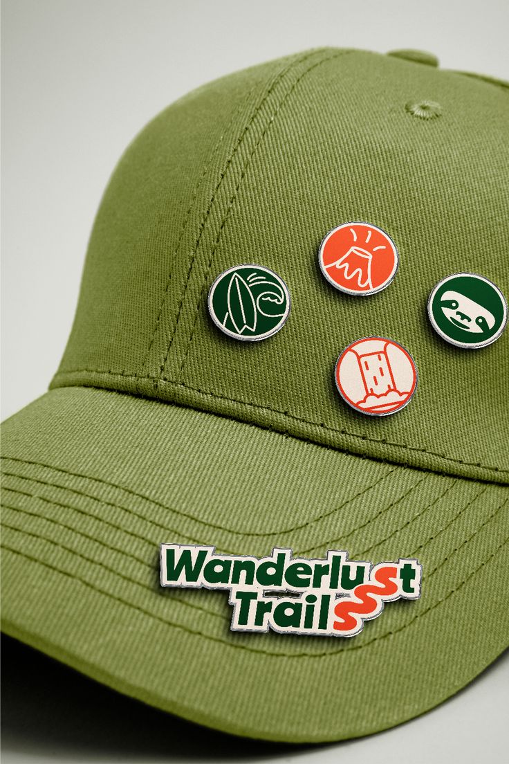 a green hat with several stickers on it's front and side panels that say wanderlust trail