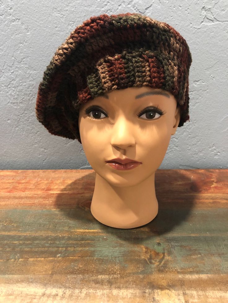 Hand crocheted multi-colored deep earth toned beret style hat. Lightweight acrylic yarn. Slouchy Brown Beanie For Fall, Brown Bohemian Beanie One Size, Bohemian Brown Knitted Beanie, Brown Bohemian Crochet Cap, Brown Yarn Hat, Brown Yarn Hat One Size, Brown Bohemian Crochet Hat, Brown Bohemian Crochet Beanie Hat, Bohemian Brown Crochet Hat