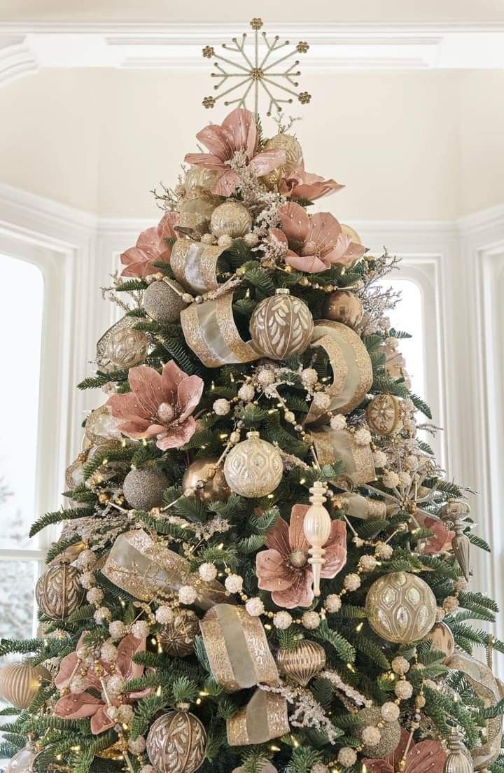 a decorated christmas tree with pink and gold ornaments